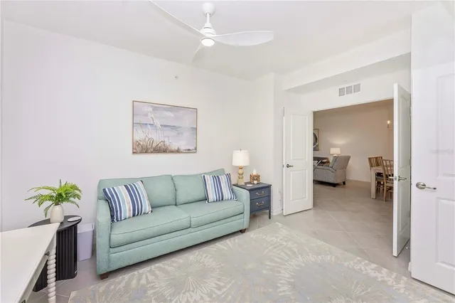a living room with furniture and a floor to ceiling window