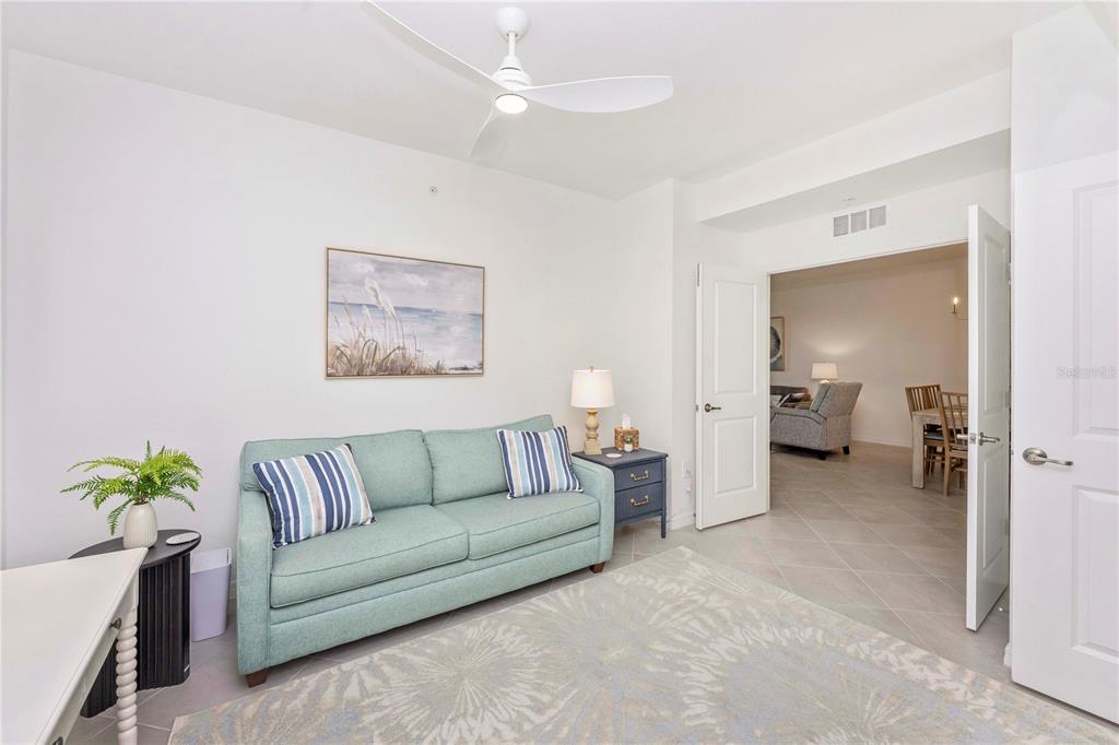 17500 Opal Sand Drive, Unit 101 Venice, FL 34293 - Photo 25 of 98 a living room with furniture and a potted plant