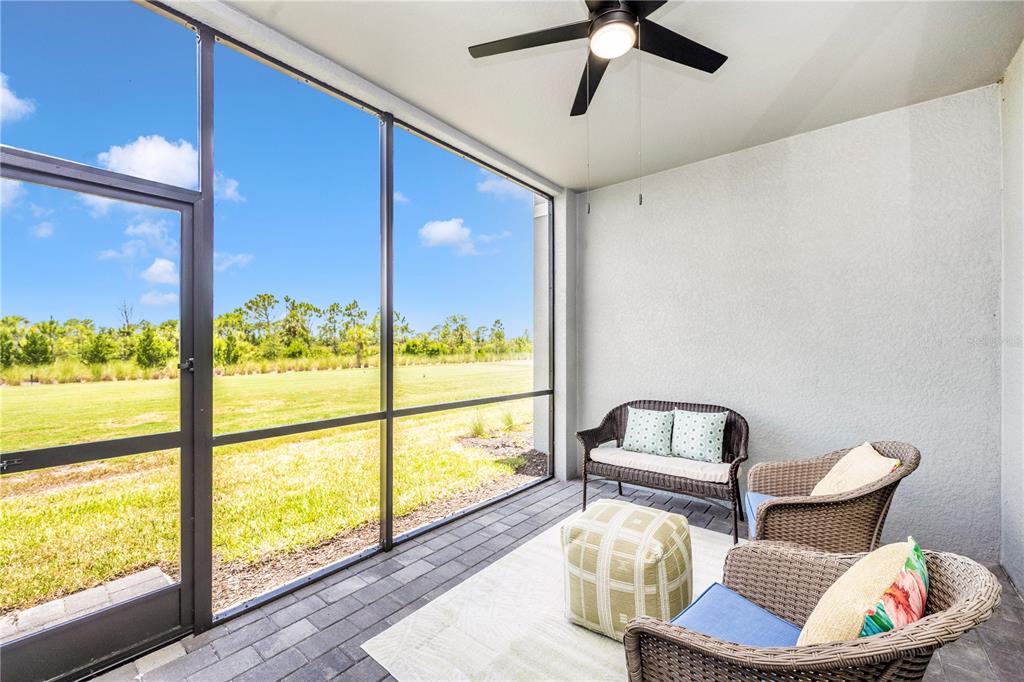 17500 Opal Sand Drive, Unit 101 Venice, FL 34293 - Photo 39 of 98 a living room with furniture and a floor to ceiling window