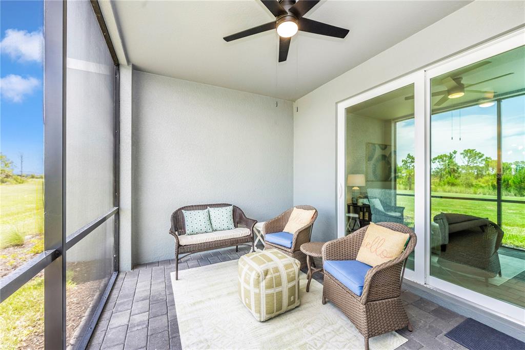 17500 Opal Sand Drive, Unit 101 Venice, FL 34293 - Photo 41 of 98 a living room with furniture and a floor to ceiling window