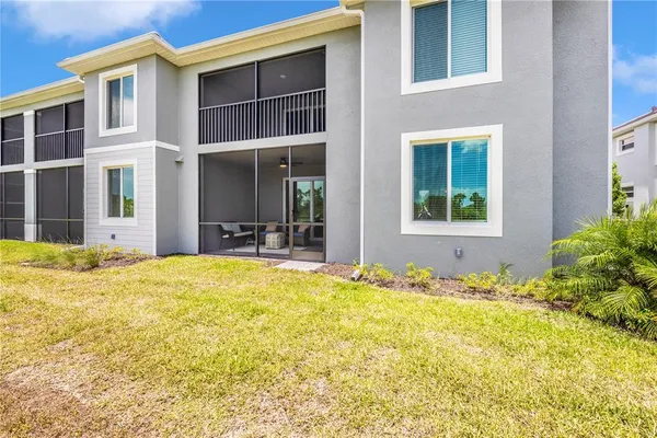 a view of a house with backyard porch and sitting area