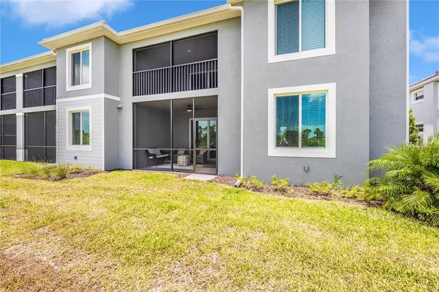 a view of a house with backyard porch and sitting area