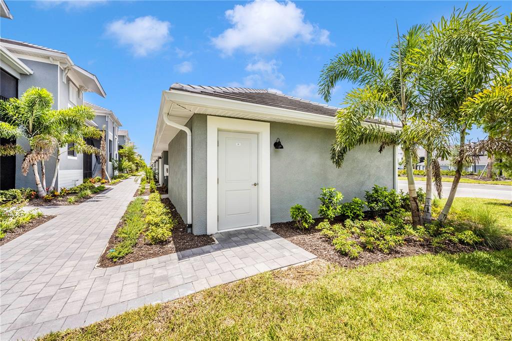 17500 Opal Sand Drive, Unit 101 Venice, FL 34293 - Photo 50 of 98 a front view of a house with a yard