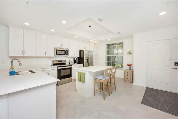 a kitchen with stainless steel appliances a refrigerator stove microwave and sink