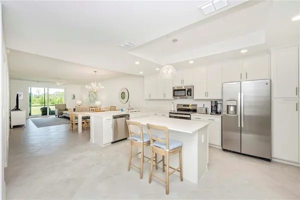 a view of a dining room with furniture and a chandelier