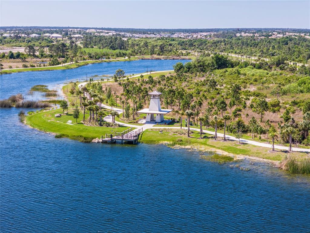 17500 Opal Sand Drive, Unit 101 Venice, FL 34293 - Photo 98 of 98 a view of a swimming pool with an ocean and trees