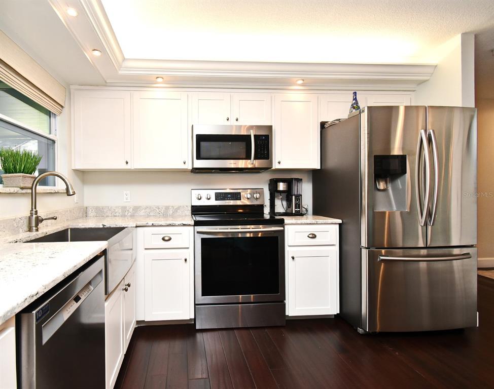 1312 2nd Street Edgewater, FL 32132 - Photo 15 of 41 a kitchen with a refrigerator stove and sink