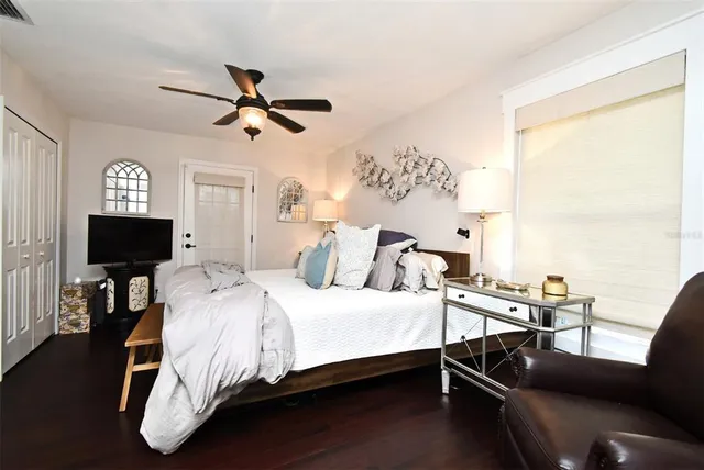 a bedroom with a bed and a painting on the wall