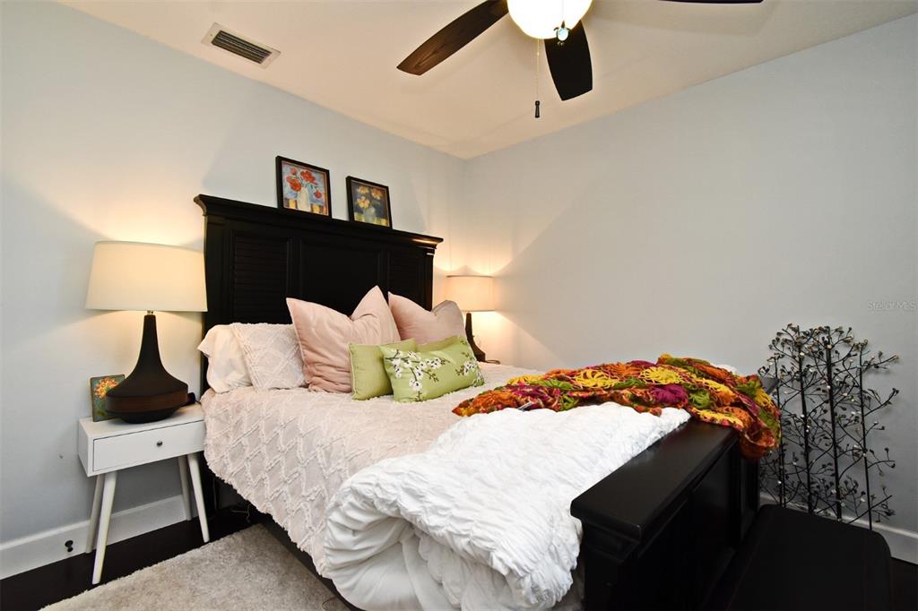 1312 2nd Street Edgewater, FL 32132 - Photo 28 of 41 a bedroom with a bed and lamp on the dresser