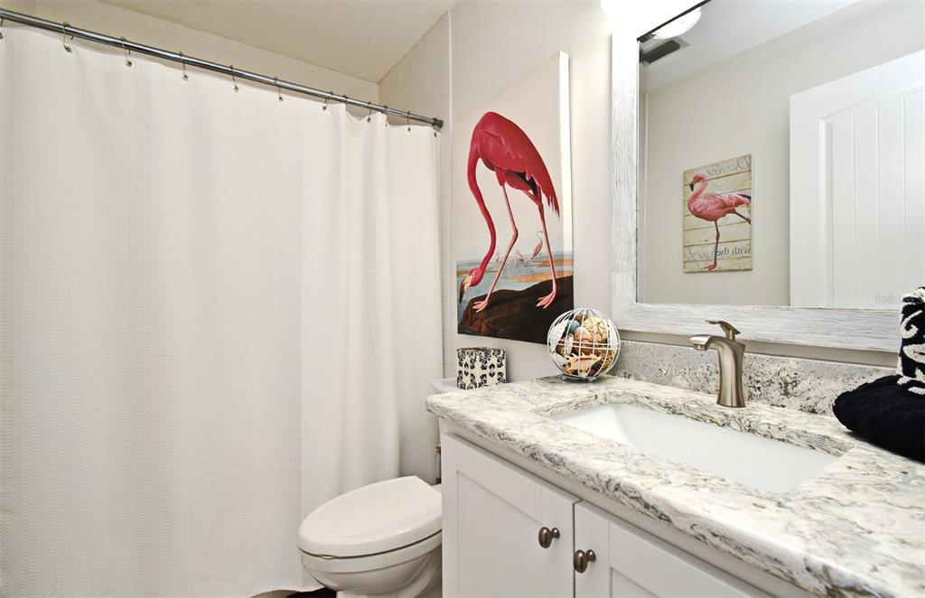 1312 2nd Street Edgewater, FL 32132 - Photo 30 of 41 a bathroom with a granite countertop sink and a mirror
