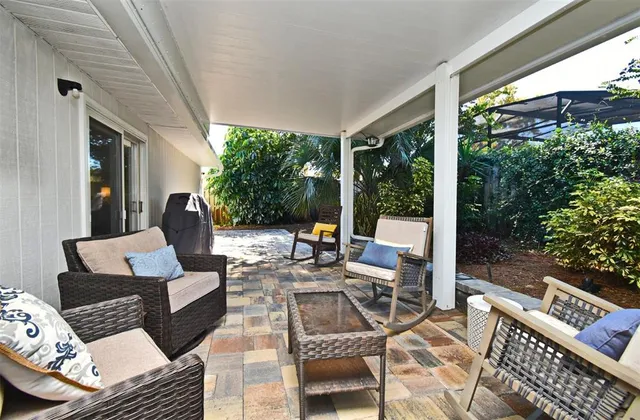 a view of a chairs and table in the patio
