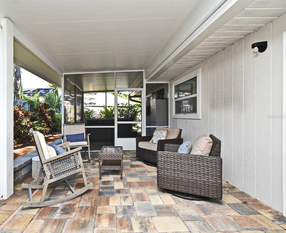 1312 2nd Street Edgewater, FL 32132 - Photo 33 of 41 a outdoor space with patio the couches and a dining table with garden view