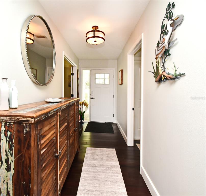 1312 2nd Street Edgewater, FL 32132 - Photo 8 of 41 a view of a hallway with wooden floor and staircase