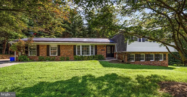 a view of a house with a yard and sitting area