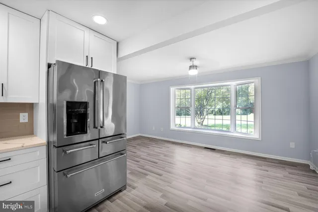 a kitchen with stainless steel appliances granite countertop a refrigerator and a stove
