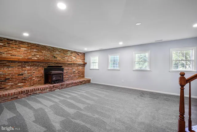 a view of an empty room with a fireplace