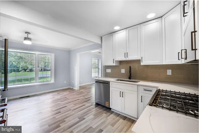 a kitchen with stainless steel appliances a stove top oven