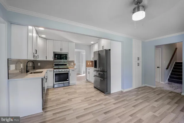 a kitchen with stove cabinets and refrigerator