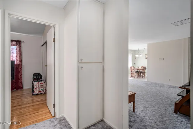 a view of a room with furniture and windows