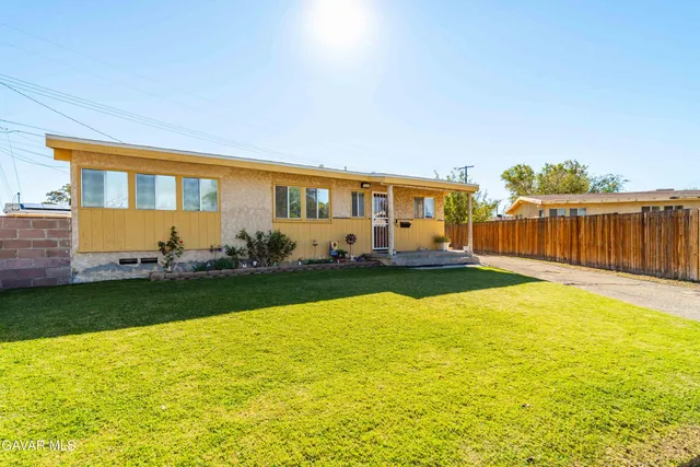 a front view of a house with swimming pool having outdoor seating