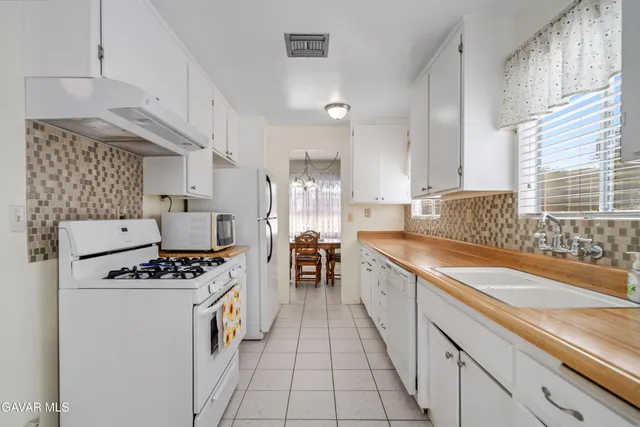 a view of washer and dryer with bathroom in the background