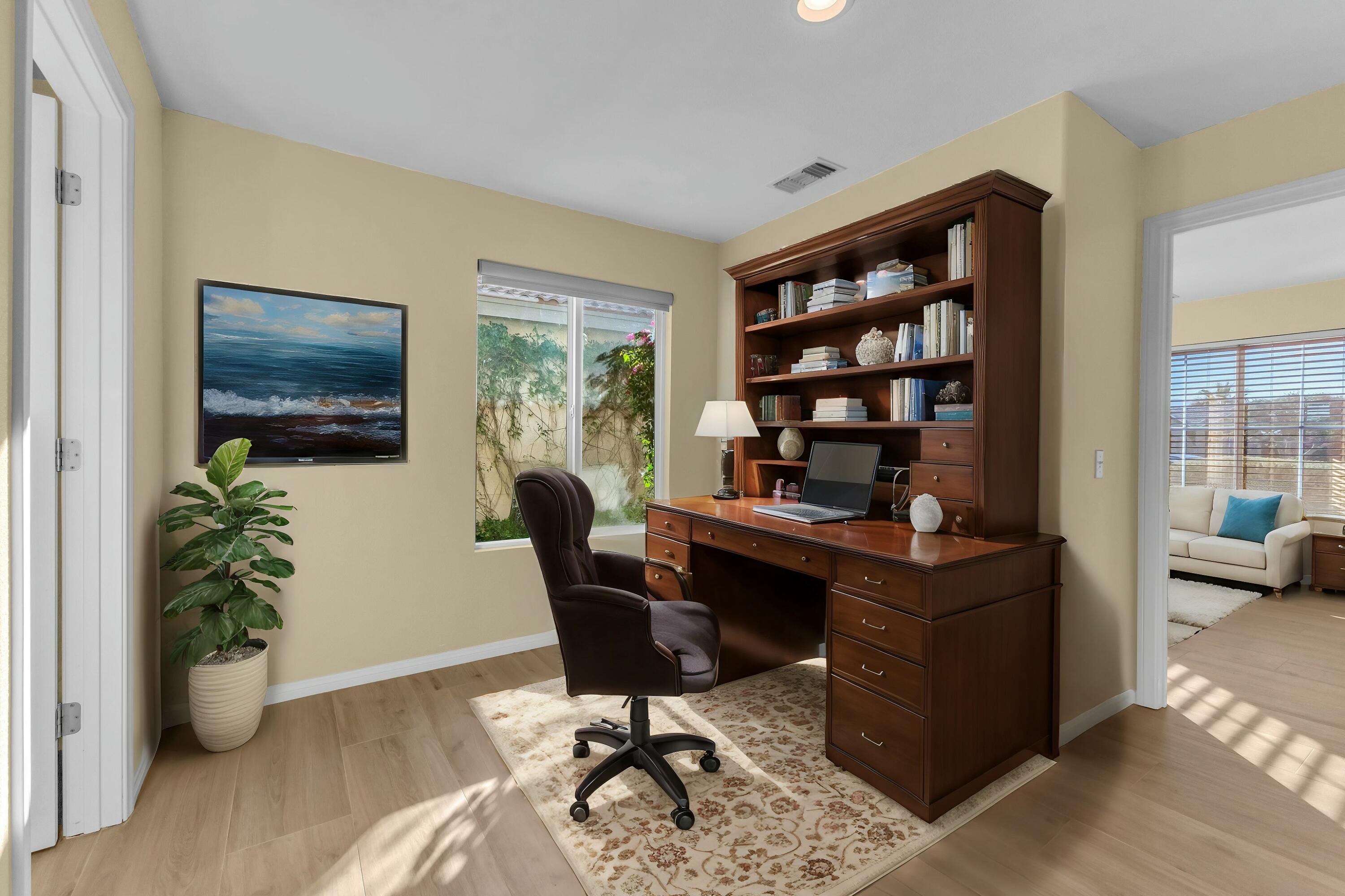 83480 Firecliff Court Indio, CA 92203 - Photo 12 of 61 a view of a workspace with furniture and a potted plant
