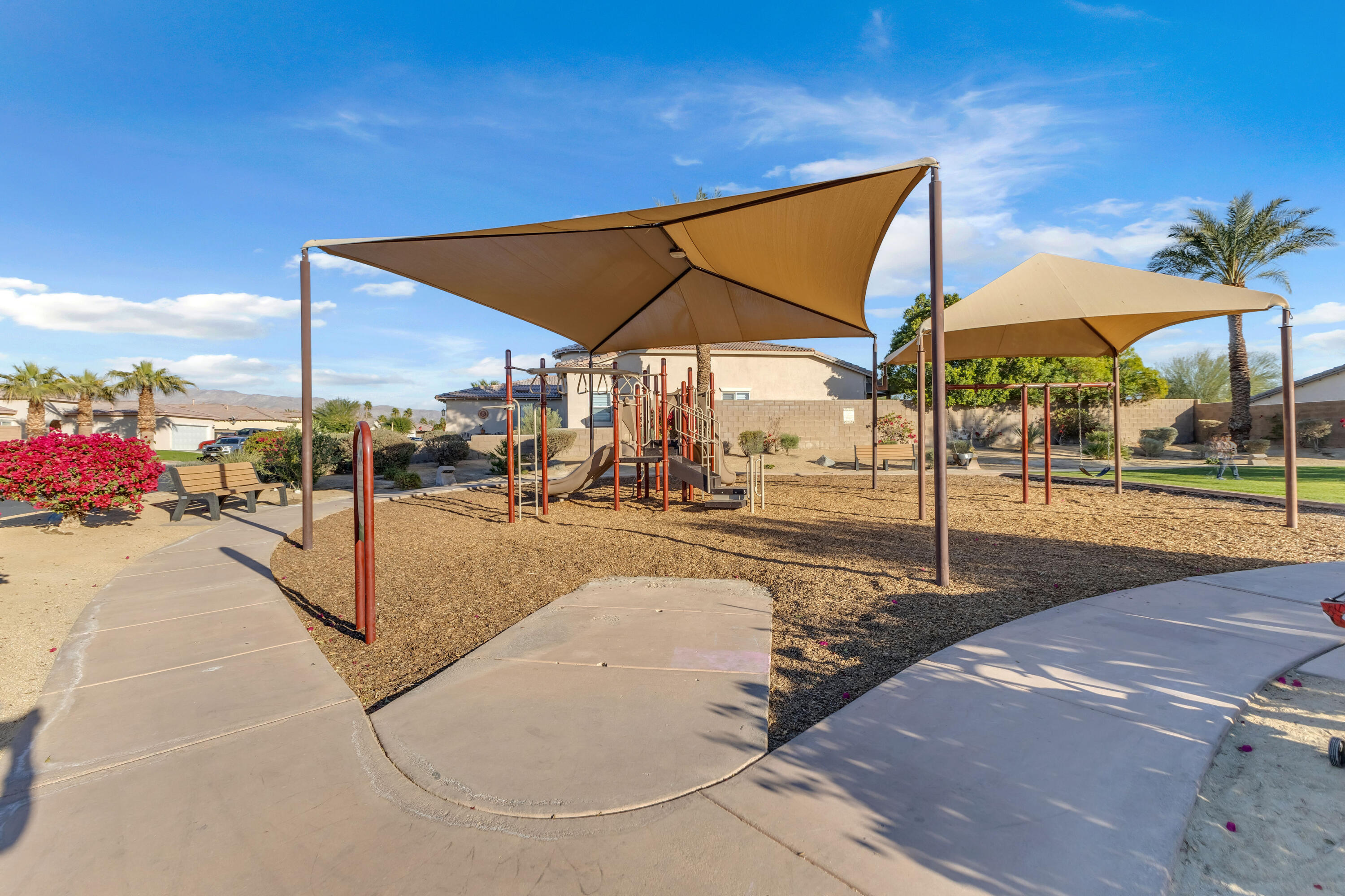 83480 Firecliff Court Indio, CA 92203 - Photo 23 of 61 a view of a patio with a table and chairs under an umbrella