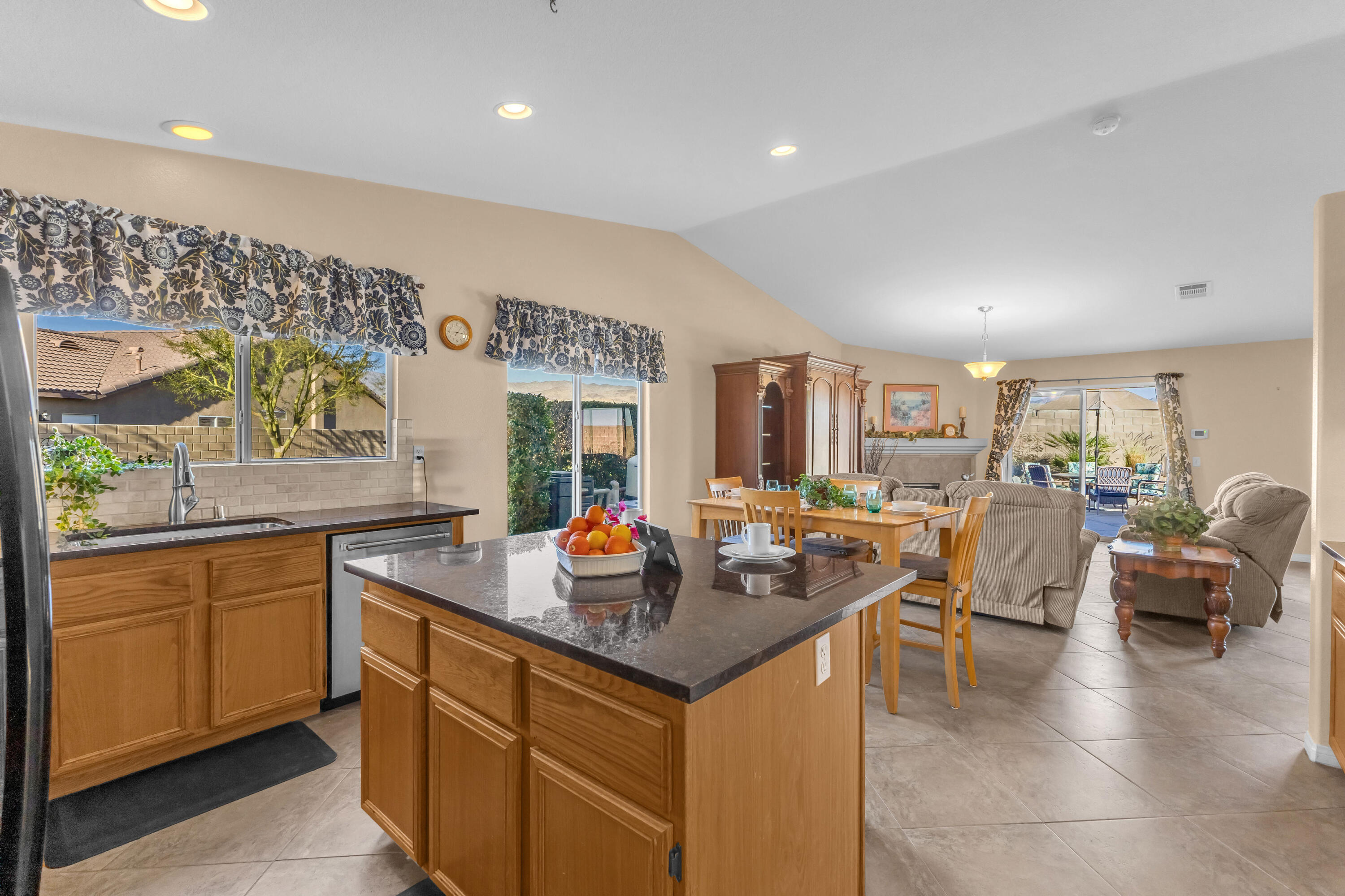 83480 Firecliff Court Indio, CA 92203 - Photo 30 of 61 a living room with stainless steel appliances granite countertop a sink and a refrigerator