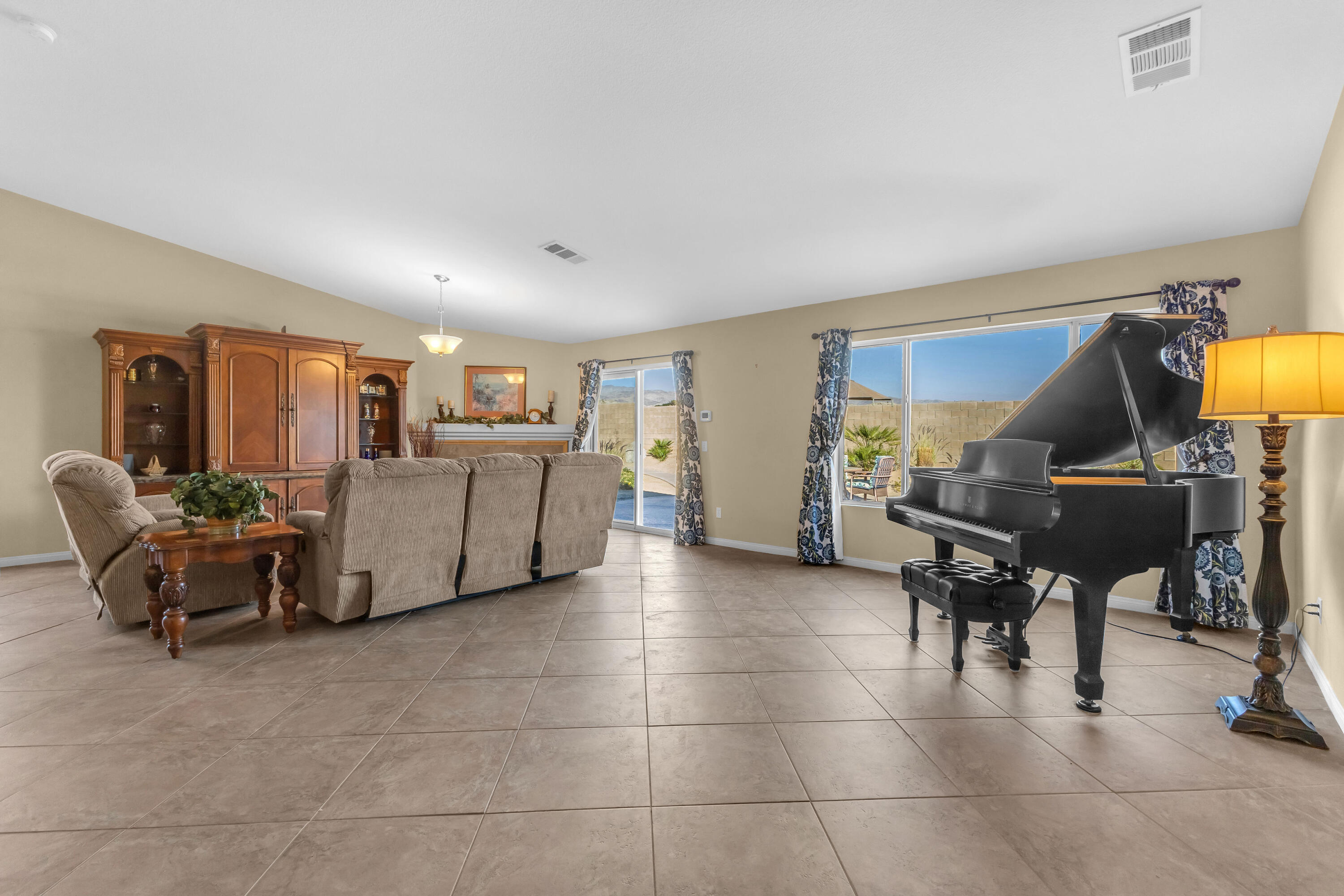 83480 Firecliff Court Indio, CA 92203 - Photo 32 of 61 a living room with furniture and a piano table