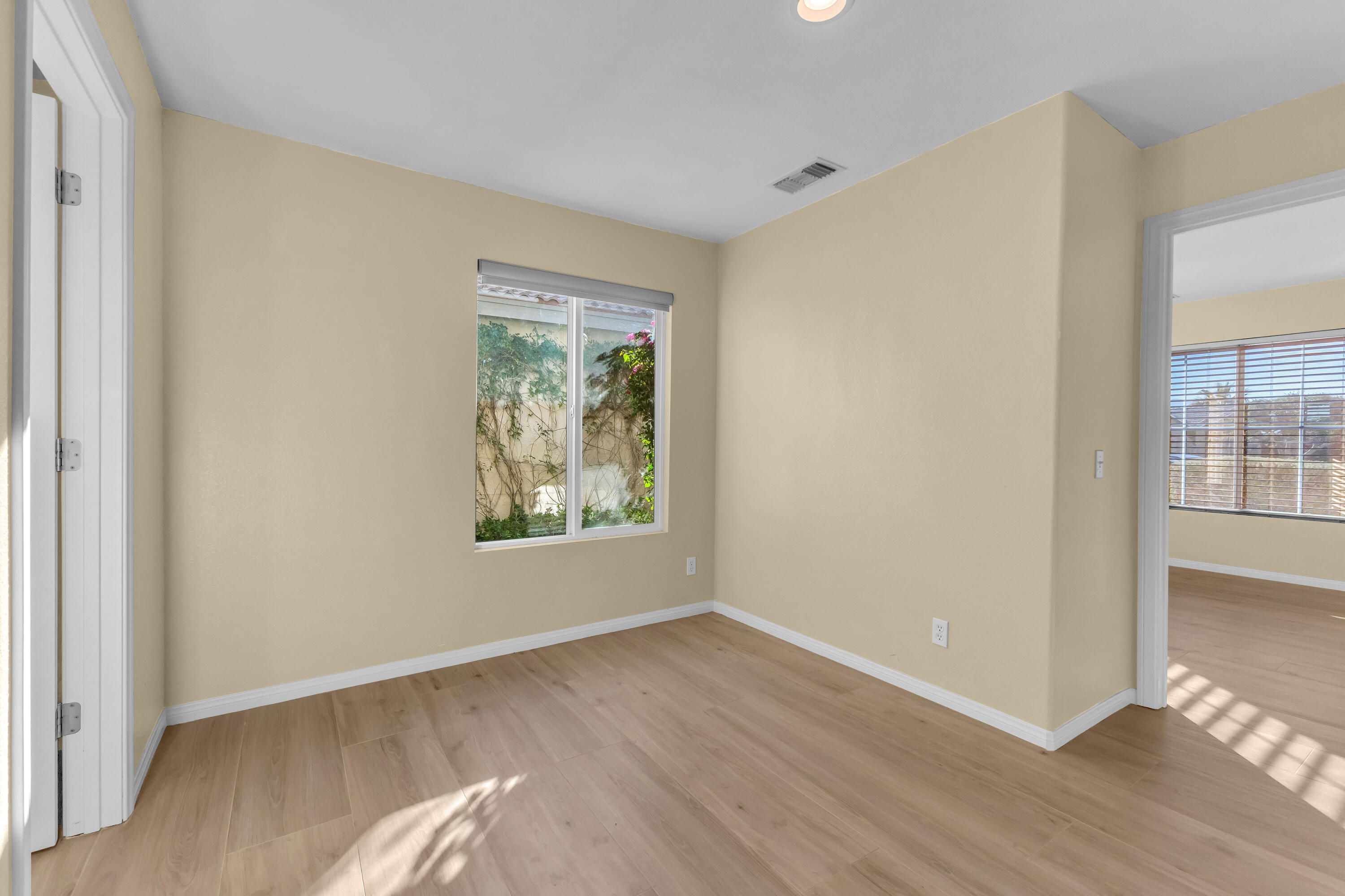 83480 Firecliff Court Indio, CA 92203 - Photo 41 of 61 a view of an empty room with wooden floor and a window