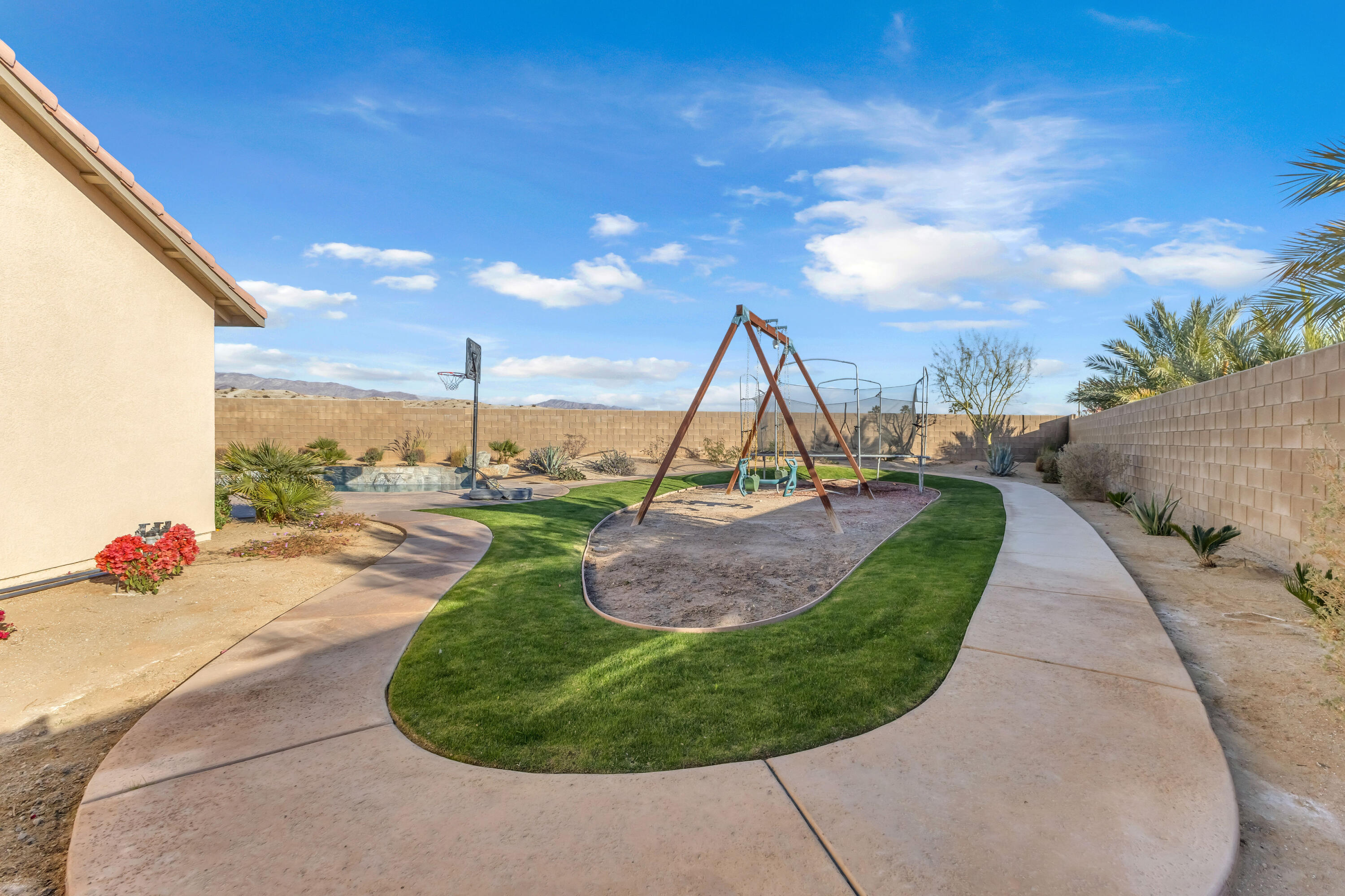 83480 Firecliff Court Indio, CA 92203 - Photo 56 of 61 a view of a swimming pool with a sitting space