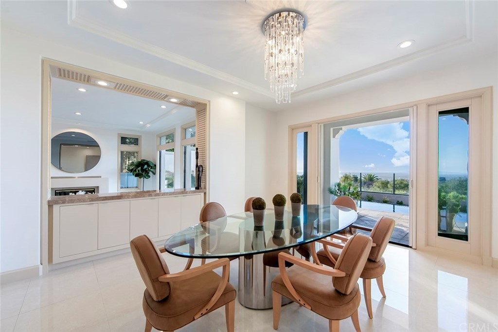 11 Vista Luci Newport Coast, CA 92657 - Photo 15 of 63 a view of a dining room with furniture a chandelier and wooden floor