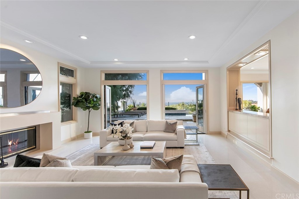 11 Vista Luci Newport Coast, CA 92657 - Photo 18 of 63 a living room with fireplace furniture and a large window