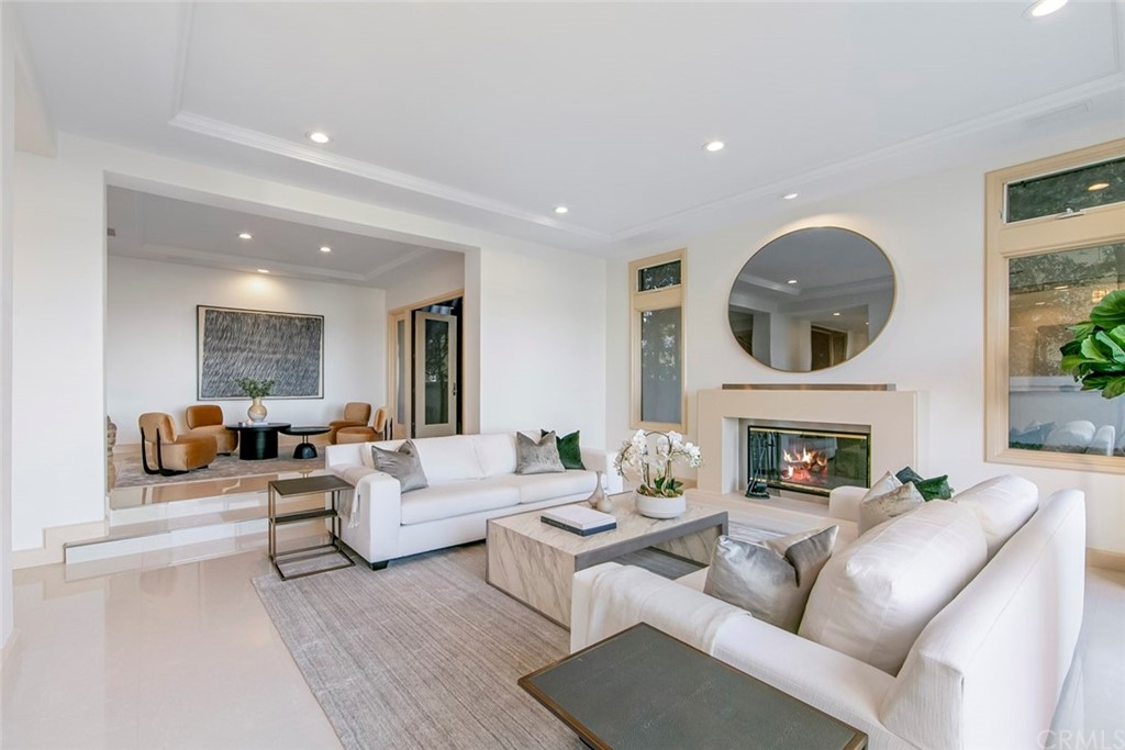 11 Vista Luci Newport Coast, CA 92657 - Photo 24 of 63 a living room with furniture a fireplace and a potted plant