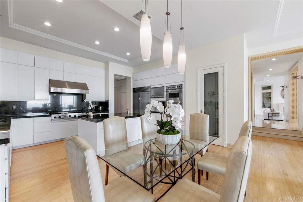 11 Vista Luci Newport Coast, CA 92657 - Photo 26 of 63 a large kitchen with a table and chairs in it