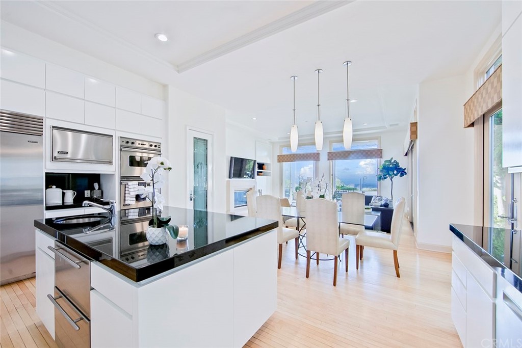 11 Vista Luci Newport Coast, CA 92657 - Photo 27 of 63 a kitchen with stainless steel appliances granite countertop a sink and a refrigerator