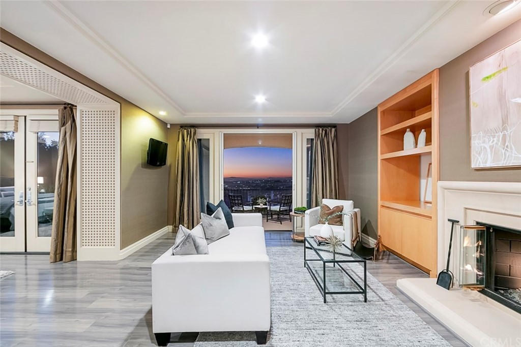 11 Vista Luci Newport Coast, CA 92657 - Photo 54 of 63 a living room with furniture a fireplace and a flat screen tv