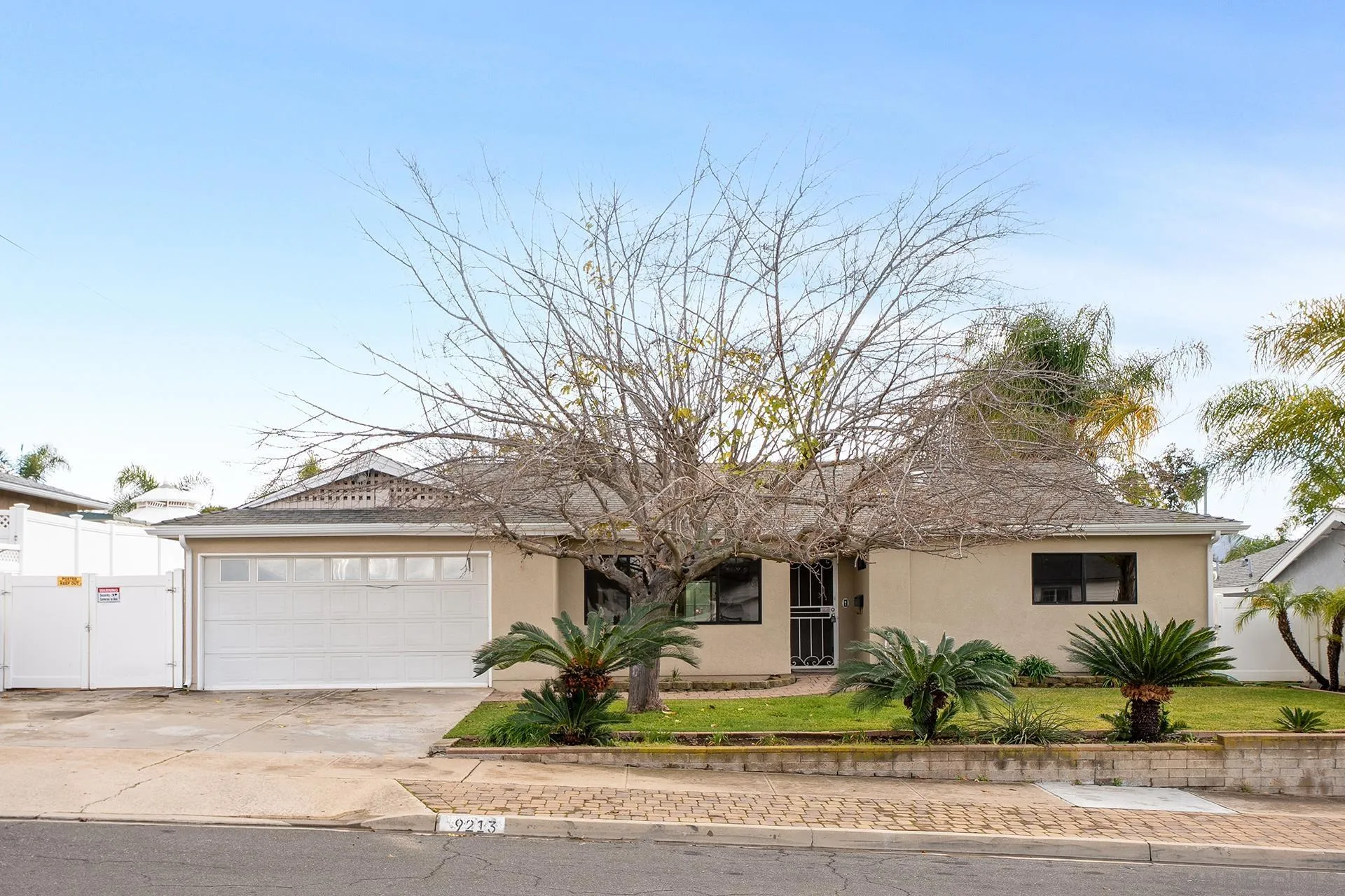 9213 Fenway Road Santee, CA 92071 - Photo 1 of 25 a front view of a house with a yard and garage