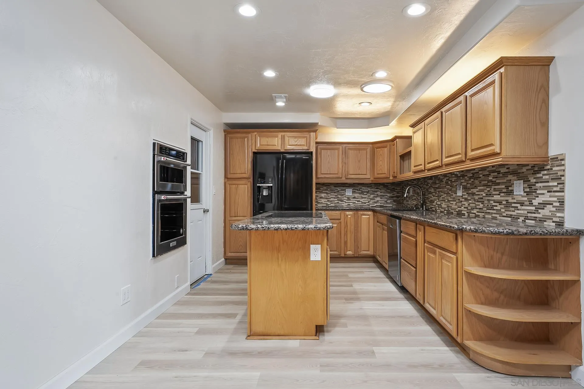 9213 Fenway Road Santee, CA 92071 - Photo 3 of 25 a large kitchen with stainless steel appliances granite countertop a stove a sink and a refrigerator