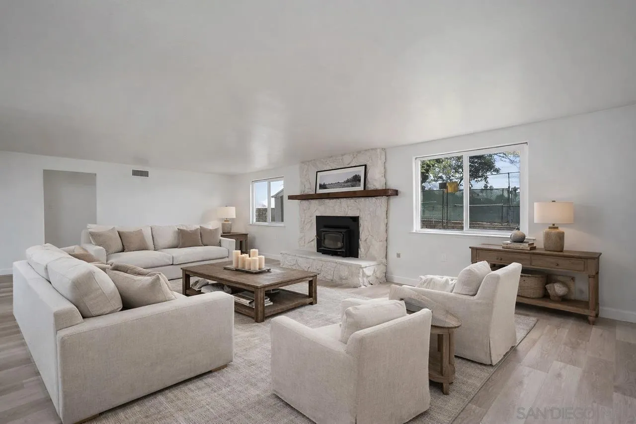 9213 Fenway Road Santee, CA 92071 - Photo 8 of 25 a living room with furniture window and a fireplace