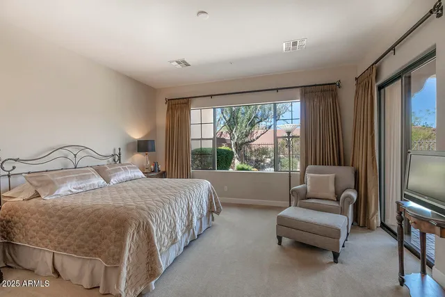 a bedroom with a bed and a couch