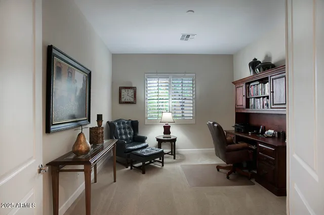 a livingroom with workspace and a window