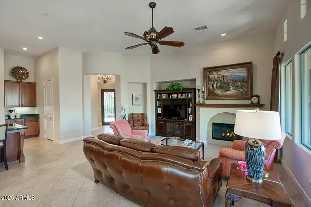 a living room with furniture a fireplace and a flat screen tv