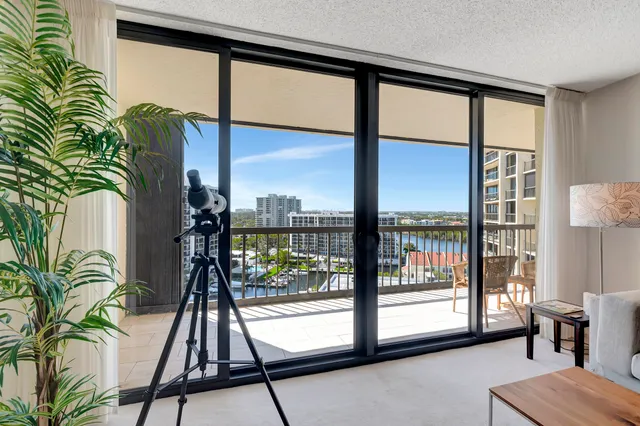 a floor to ceiling window with a potted plant on a table