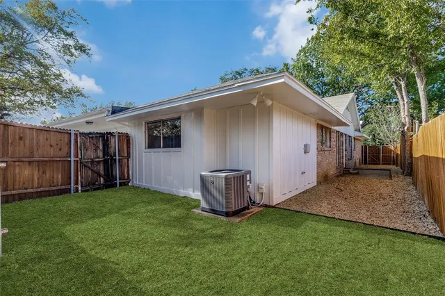a backyard of a house with barbeque oven and outdoor seating