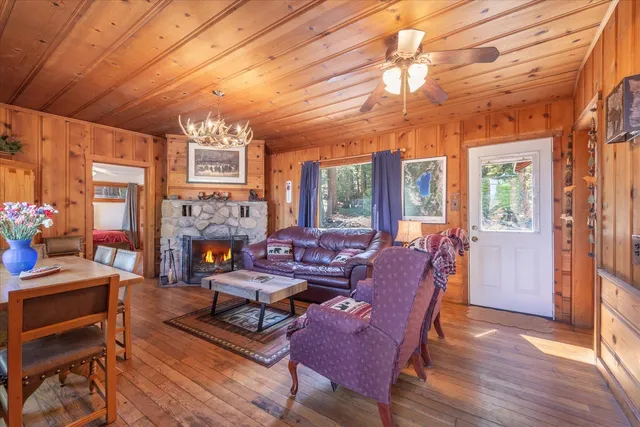 a living room with furniture a fireplace and a table