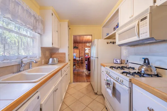 a kitchen with a sink a stove and cabinets