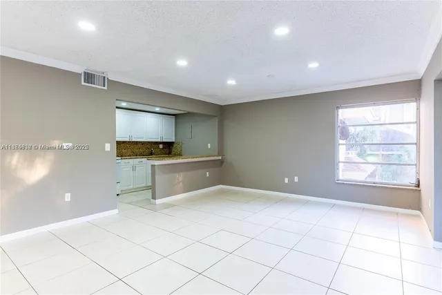a large white kitchen with a sink