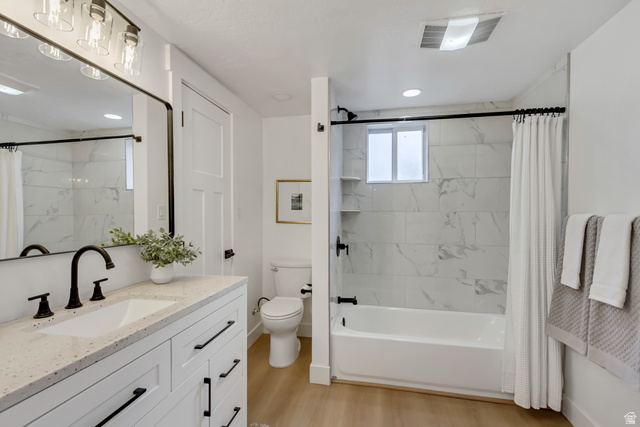 337 West 2900th Street South Bountiful, UT 84010 - Photo 26 of 35 Bathroom with vanity, shower / bath combo with shower curtain, light wood-style flooring, and recessed lighting