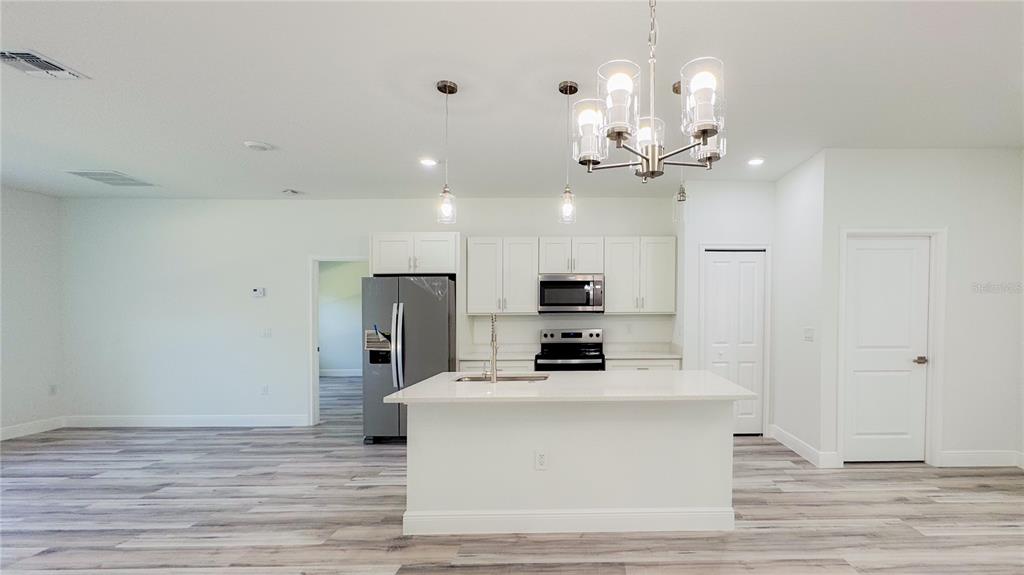 15625 Southwest 37th Circle Ocala, FL 34473 - Photo 5 of 27 a view of a kitchen with a sink and refrigerator